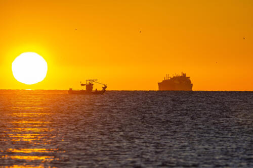 Boats passing through the Strait of Gibraltar during sunrise